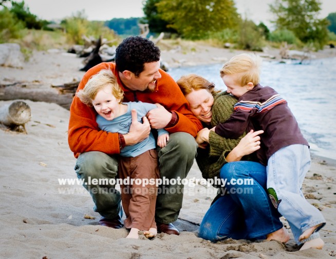 family laughing on the beach